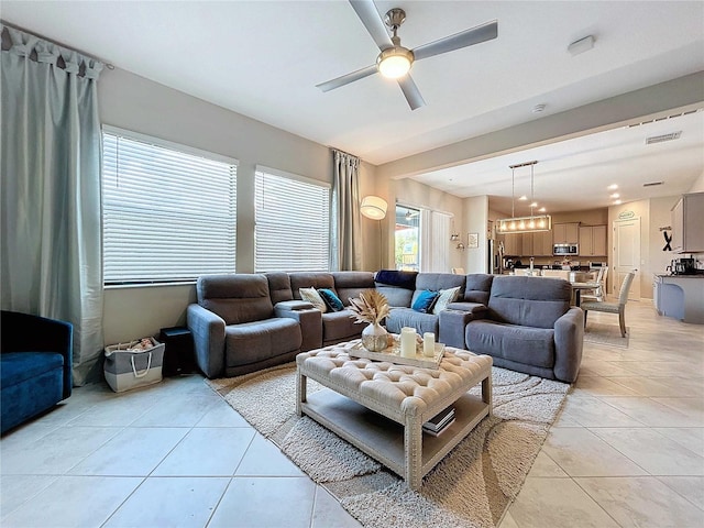 tiled living room with ceiling fan