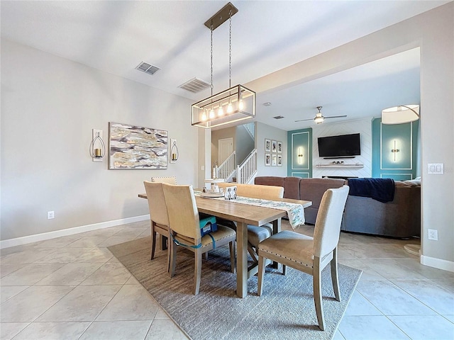 tiled dining area with ceiling fan