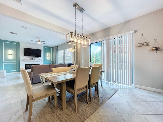 tiled dining room with ceiling fan