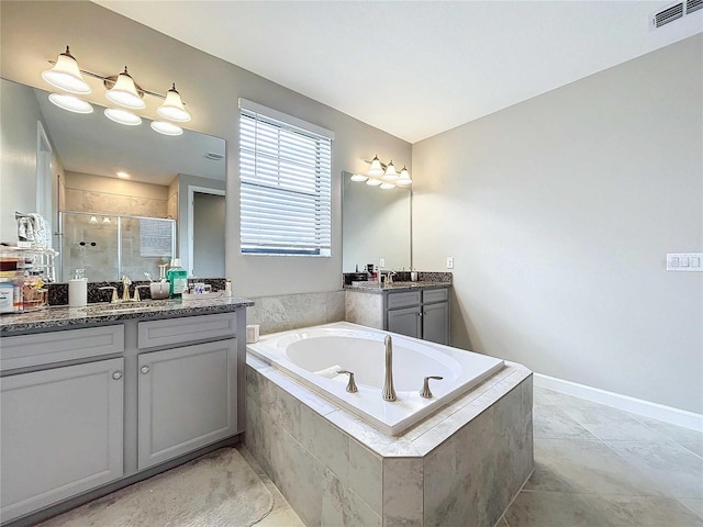 bathroom featuring vanity and independent shower and bath