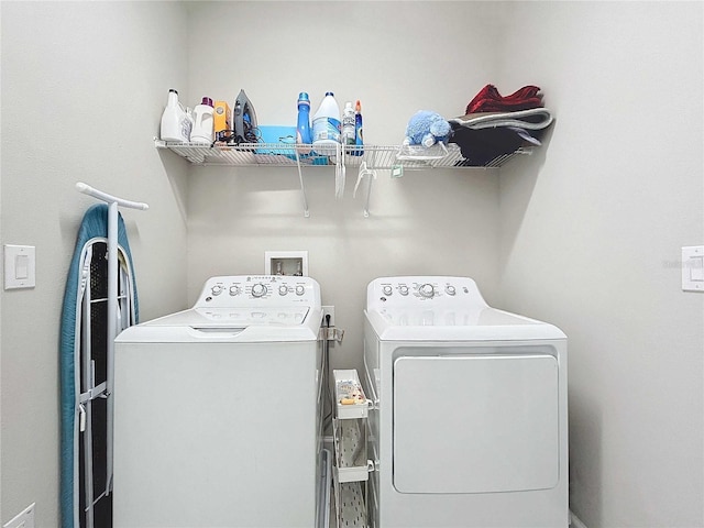 clothes washing area featuring washer and dryer