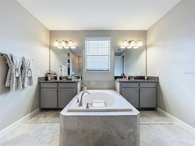 bathroom featuring vanity and tiled bath