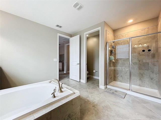 bathroom featuring separate shower and tub and toilet