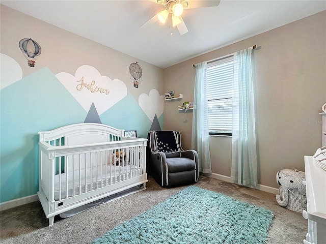 bedroom featuring ceiling fan, carpet floors, and a nursery area