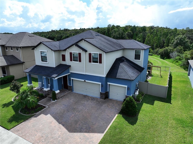 view of front of home featuring a front lawn, a porch, and a garage