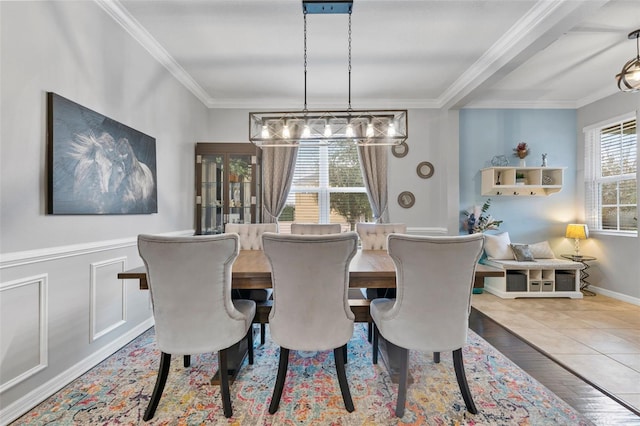 tiled dining space featuring crown molding