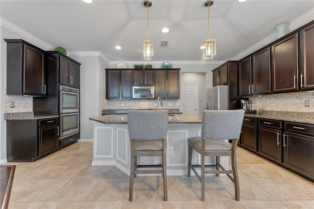 kitchen with decorative light fixtures, stainless steel appliances, crown molding, dark stone counters, and dark brown cabinetry