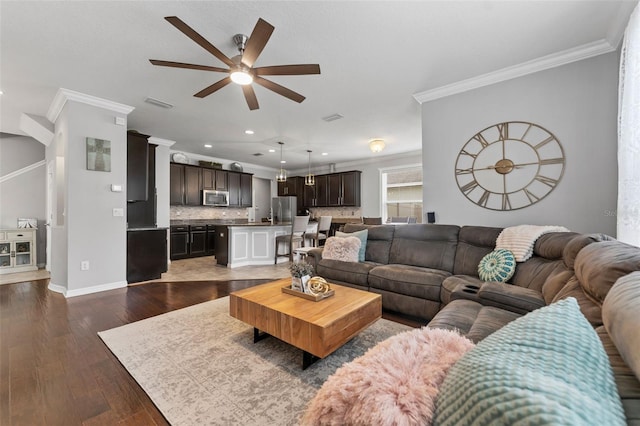 living room with ceiling fan, dark hardwood / wood-style flooring, and ornamental molding