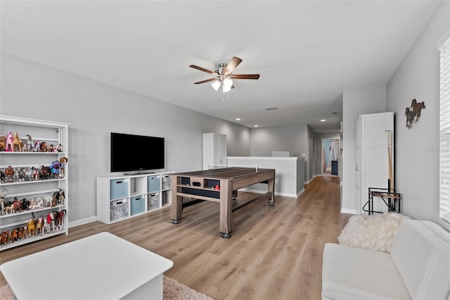 living room featuring ceiling fan and light hardwood / wood-style floors