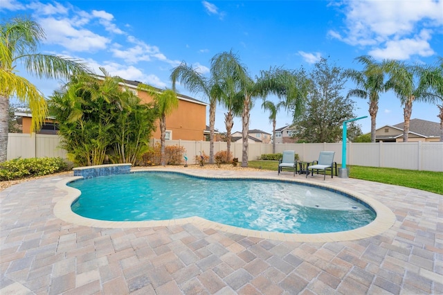 view of swimming pool with a patio and pool water feature