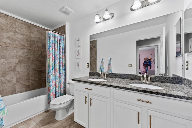 full bathroom with toilet, shower / bath combo, vanity, and a textured ceiling