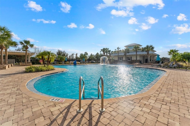 view of swimming pool with a patio and pool water feature