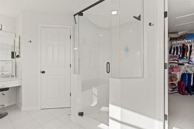 bathroom featuring a shower with shower door and tile patterned flooring