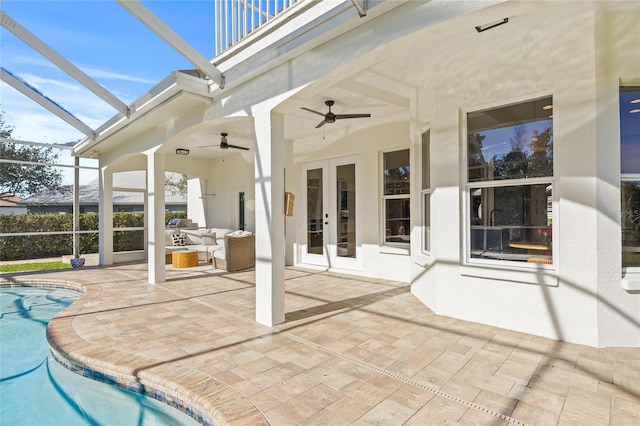 exterior space with an outdoor living space, ceiling fan, a patio, and french doors