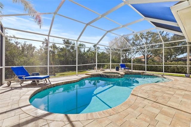 view of swimming pool featuring an in ground hot tub, a patio, and a lanai