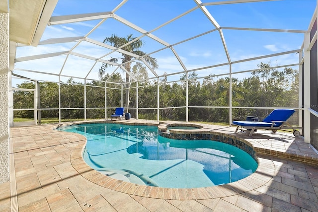 view of swimming pool featuring glass enclosure, a patio area, and an in ground hot tub