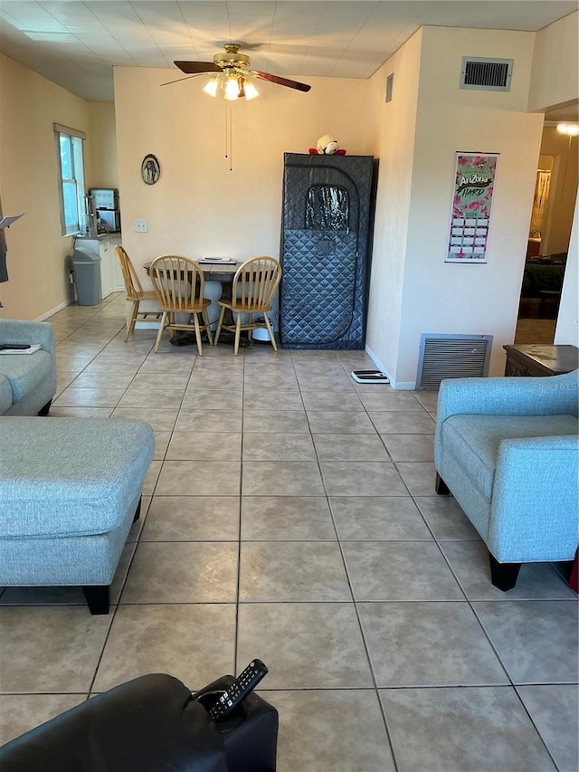 living room featuring ceiling fan and tile patterned flooring