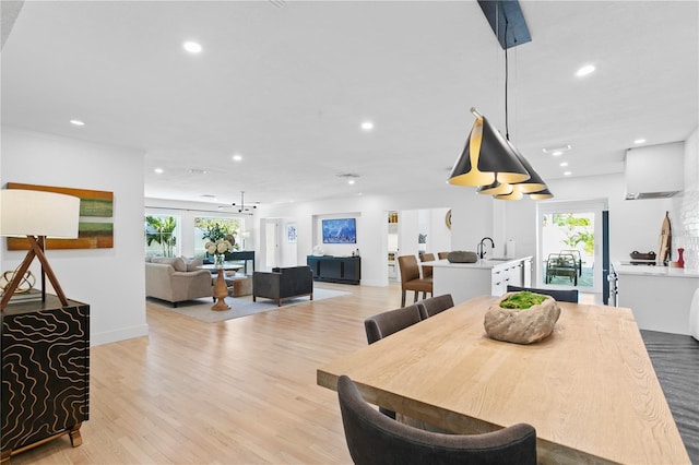 dining room featuring sink and light wood-type flooring