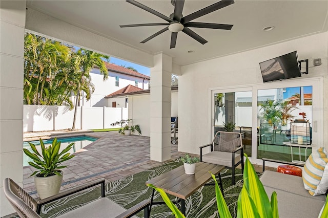 view of patio / terrace with a fenced in pool and ceiling fan