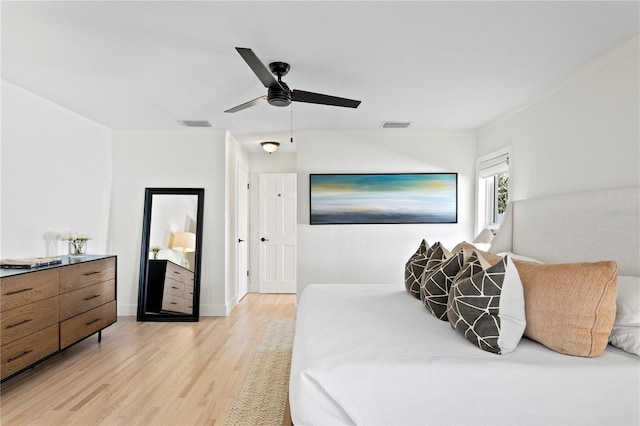 bedroom with crown molding, ceiling fan, and light hardwood / wood-style floors