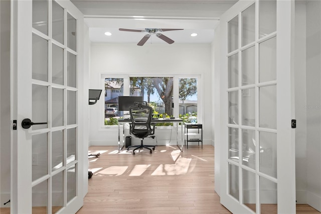 home office featuring light hardwood / wood-style floors, french doors, and ceiling fan