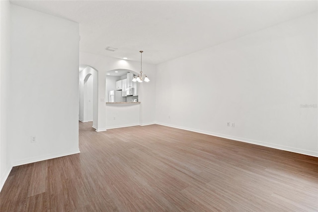 interior space with a chandelier and wood-type flooring