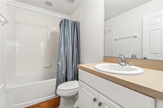 full bathroom featuring a textured ceiling, toilet, vanity, shower / tub combo, and hardwood / wood-style flooring