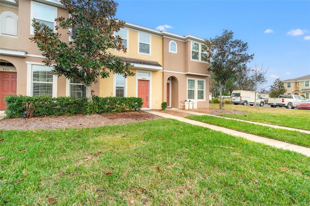 view of property featuring a front lawn