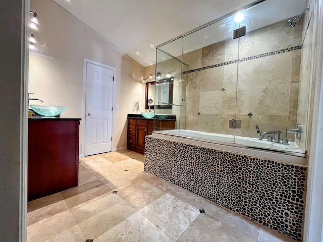 bathroom featuring lofted ceiling, vanity, and shower / bath combination with glass door