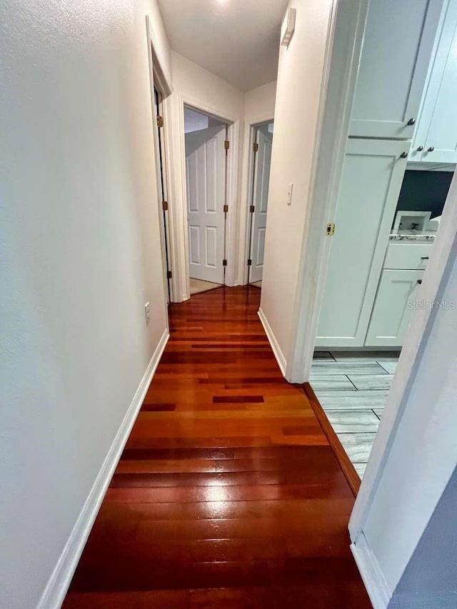 corridor featuring dark hardwood / wood-style floors