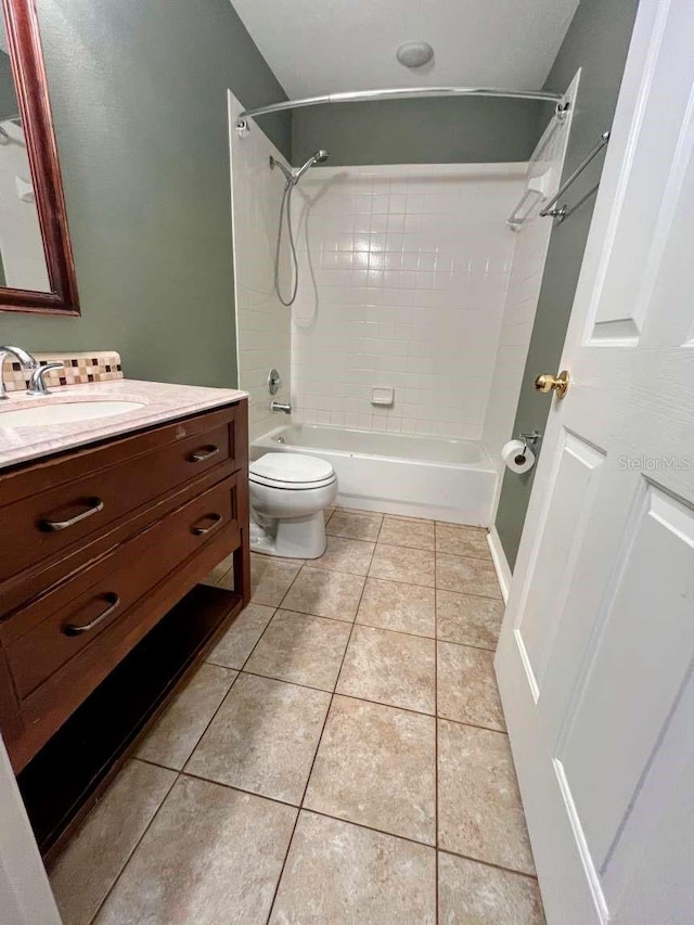 full bathroom with tiled shower / bath combo, vanity, tile patterned floors, and toilet