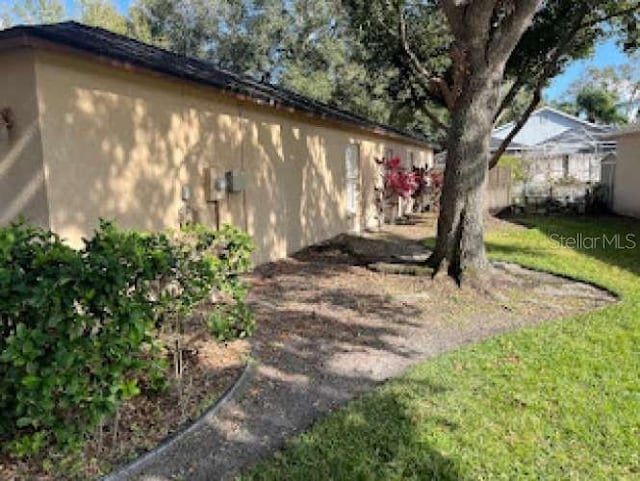 view of side of home featuring a lawn