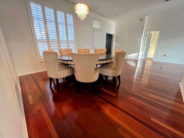 dining room featuring an inviting chandelier and dark hardwood / wood-style floors