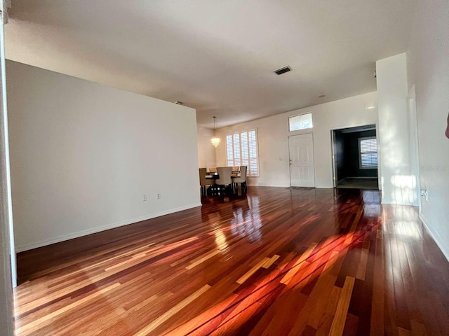 unfurnished living room featuring dark wood-type flooring