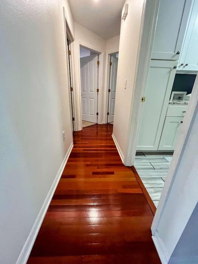 hall with dark wood-type flooring