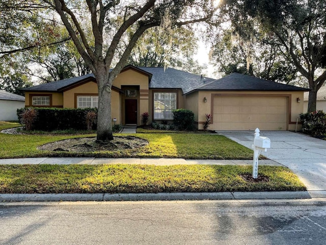 ranch-style house featuring a garage and a front lawn