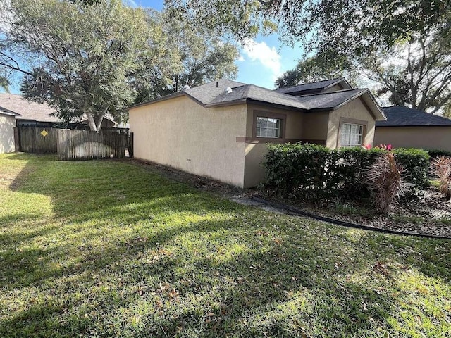 view of side of property with a yard