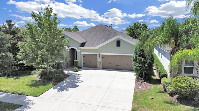 view of front facade with stucco siding, concrete driveway, an attached garage, stone siding, and a front lawn