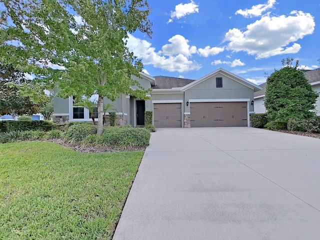 view of front facade with a front yard and a garage