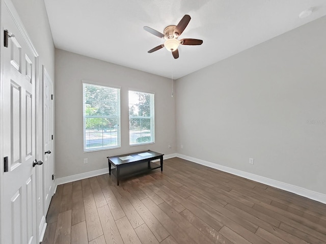 spare room featuring ceiling fan and dark wood-type flooring