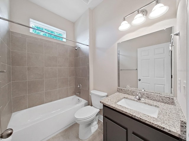 full bathroom with vanity, tiled shower / bath combo, toilet, and tile patterned flooring