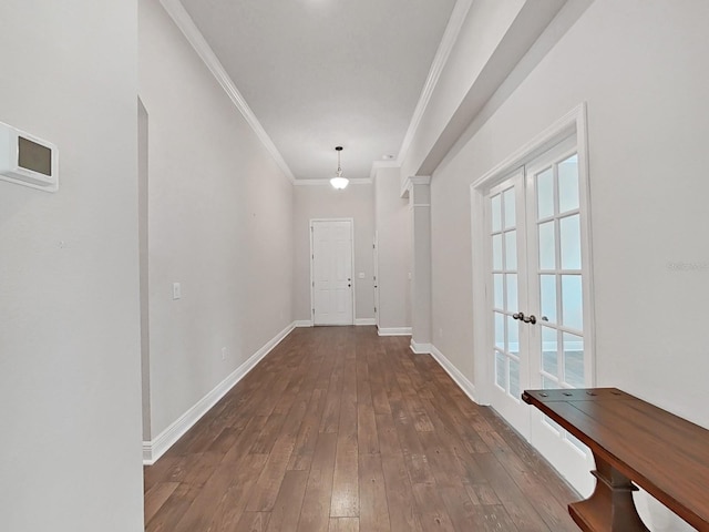 hallway with dark hardwood / wood-style flooring, ornamental molding, and french doors