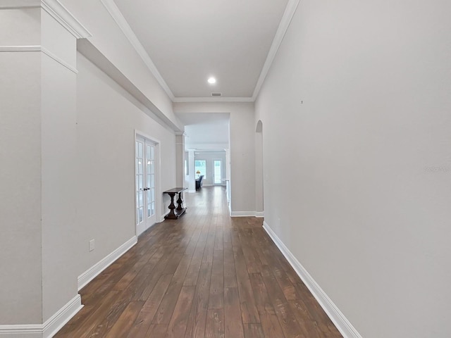 hall featuring crown molding, french doors, and dark wood-type flooring