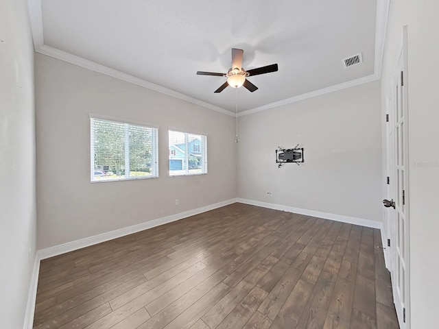 spare room with dark hardwood / wood-style floors, ceiling fan, and ornamental molding