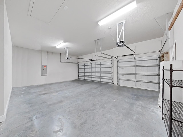 garage featuring electric panel and a garage door opener