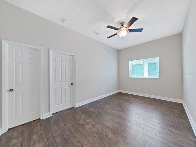 unfurnished bedroom featuring ceiling fan and dark hardwood / wood-style floors