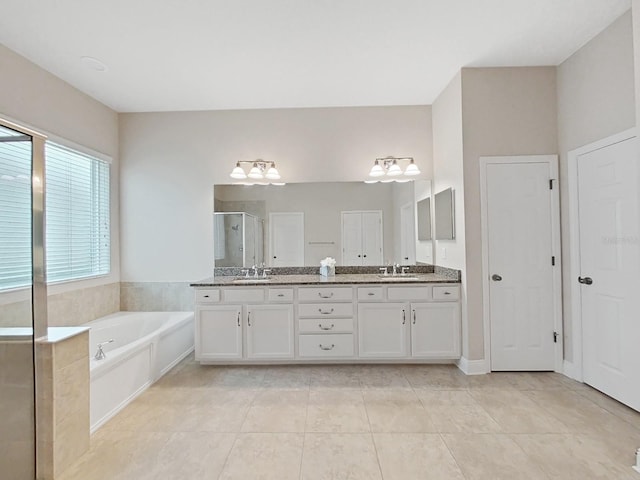 bathroom with tile patterned flooring, vanity, and independent shower and bath