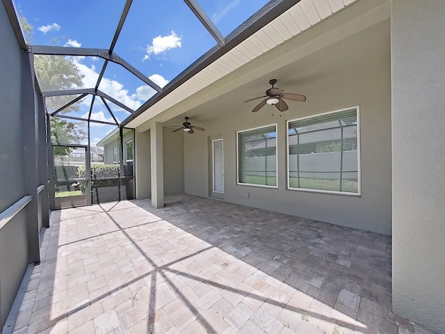 unfurnished sunroom with ceiling fan and a healthy amount of sunlight