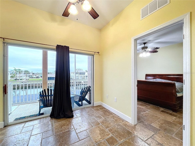 interior space featuring ceiling fan and a water view