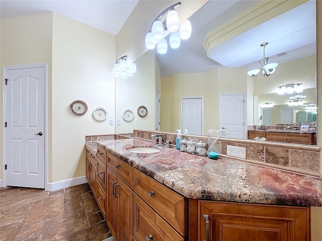 bathroom featuring vanity and a chandelier